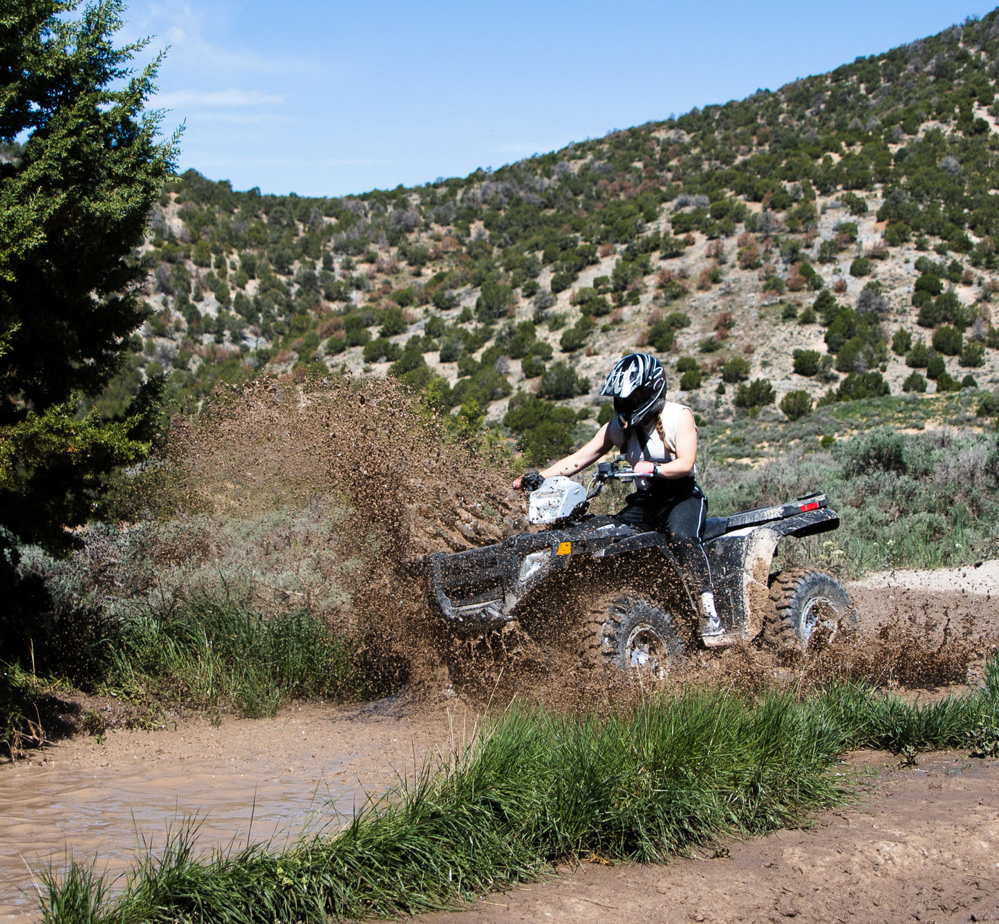 Trail-ready ATV with helmet and gear